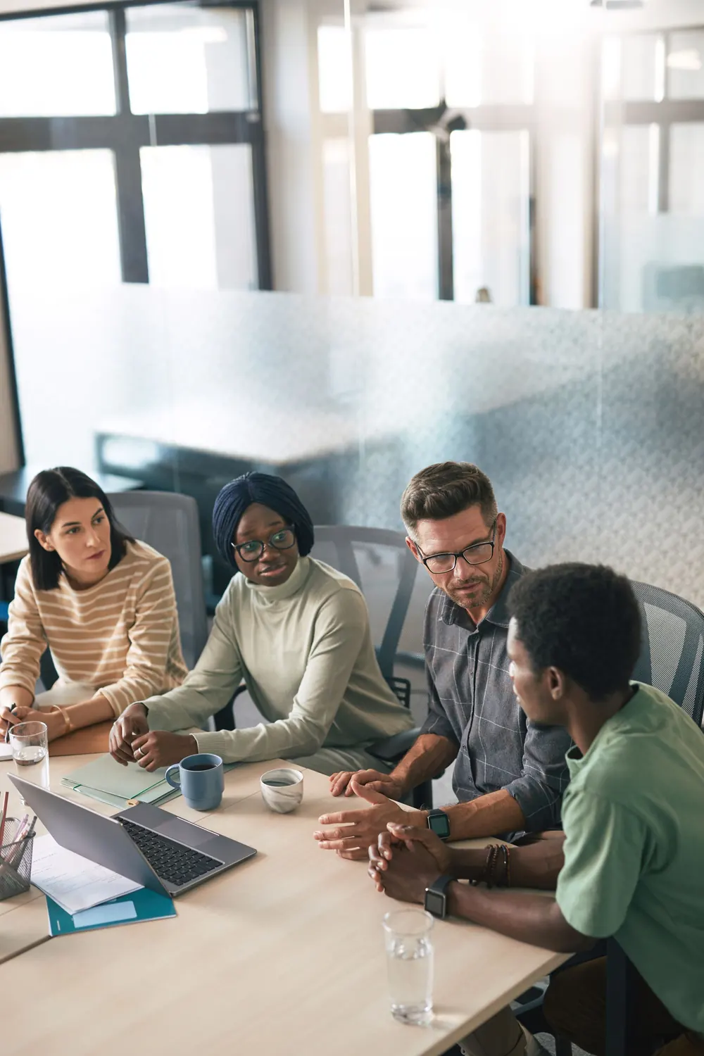 A small team in discussion around a meeting table